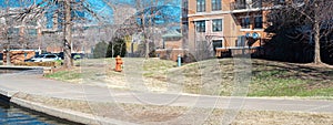 Panorama riverside buildings hotels along canal with curved sidewalk pathway in Bricktown, Entertainment District, Oklahoma City, photo