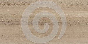 panorama of road from above on surface of gravel road with car tire tracks in countryside