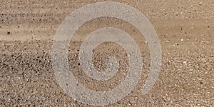 panorama of road from above on surface of gravel road with car tire tracks