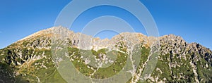 Panorama of rocky mountain range Granaty and Krzyzne pass in Five Polish Ponds Valley in Tatra Mountains, Poland