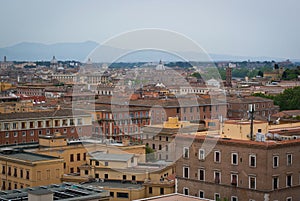 Panorama of Rome, Italy on a cloudy day. Mountain silhouettes on the horizon.