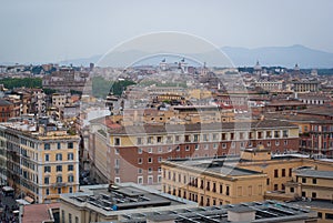 Panorama of Rome, Italy on a cloudy day. Mountain silhouettes on the horizon.