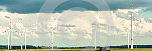 Panorama of a rural wind farm with wind turbines