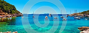 Panorama of sailboats at Cala Salada lagoon