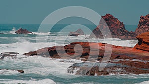 Panorama of sandstone rock formations in Legzira Beach. Rugged coast in Tiznit Province. Sea in Morocco, Africa. Atlantic Ocean.