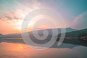 Panorama scenic of mountain lake with perfect reflection at sunrise. beautiful mountain range landscape with pink pastel sky with