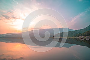 Panorama scenic of mountain lake with perfect reflection at sunrise. beautiful mountain range landscape with pink pastel sky with