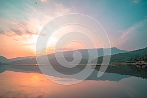 Panorama scenic of mountain lake with perfect reflection at sunrise. beautiful mountain range landscape with pink pastel sky with