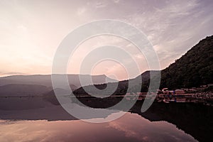 Panorama scenic of mountain lake with perfect reflection at sunrise