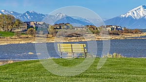 Panorama Scenic view of a lake with houses near the shore and mountain in the distance