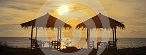Panorama of the sea sunset in Thailand. Two gazebos by the sea, on the horizon the sea and the setting sun. Vacation at