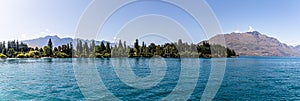 Panorama shoreline park along Lake Wakatipu Southern Alps mountain range, Ka Tiritiri o te Moana, Queenstown Otago, New Zealand