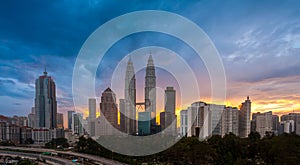 Panorama shot of sunset at Kuala Lumpur city skyline with Petronas KLCC Twin Towers,