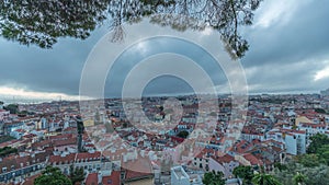 Panorama showing aerial cityscape day to night transition from Miradouro da Graca viewing point in Lisbon city after photo