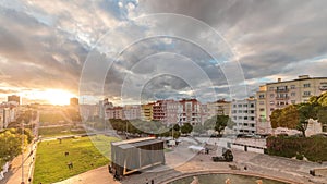 Panorama showing aerial view of Jardim da Alameda in Lisbon with the Luminous Fountain timelapse during sunset. photo