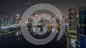 Panorama showing aerial view to Dubai Business Bay and Downtown with the various skyscrapers and towers night timelapse