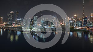 Panorama showing aerial view to Dubai Business Bay and Downtown with the various skyscrapers and towers night timelapse