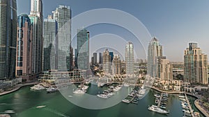 Panorama showing Dubai marina tallest skyscrapers and yachts in harbor aerial timelapse.