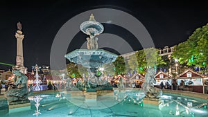 Panorama showing illuminated fountain with holiday decorations at the Rossio Christmas Market timelapse on Dom Pedro IV