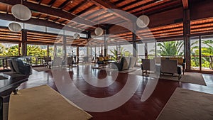 Panorama showing Interior of a modern hotel cafe bar restaurant with piano and fireplace timelapse