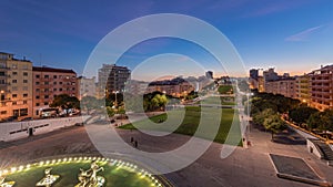 Panorama showing lawn at Alameda Dom Afonso Henriques and the Luminous Fountain aerial day to night timelapse in Lisbon. photo