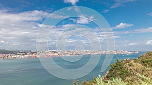 Panorama showing Lisbon cityscape and Tagus river timelapse with 25 of April bridge