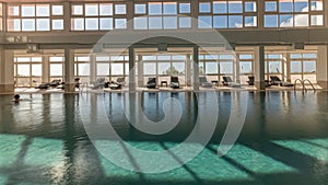 Panorama showing luxury indoor swimming pool, part of hotel timelapse