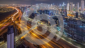 Panorama showing skyline of Dubai with business bay and downtown district night .