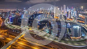 Panorama showing skyline of Dubai with business bay and downtown district night timelapse.