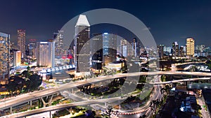 Panorama of Singapore\'s business district at night showing a skyscraper building area photo