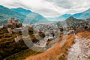 Panorama of Sion city, Rhone Valley and medieval Valere Basilica seen from Tourbillon Castle hill, canton Valais