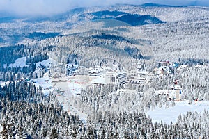 Panorama of ski resort Kopaonik, Serbia, mountains view, houses covered with snow photo
