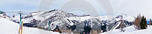 Panorama of Skiers on Chairlift Up a Ski Slope in the Canadian Rockies