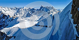 Panorama with skiers heading for Vallee Blanche, France
