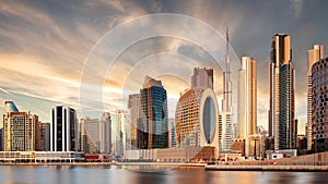 Panorama of skyline downtown Dubai at sunrise from Canal Creek, United Arab Emirates