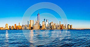 Panorama of skyline of downtown Manhattan over Hudson River under blue sky, in New York City, USA