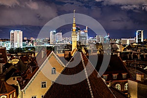 Panorama skyline of Estonian capital Talinn during night - old town in front of modern high-rise district