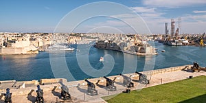 Panorama, skyline of the Maltese capital city Valletta. The Saluting Battery of La Valletta and Fort St. Angelo of La Vittoriosa i