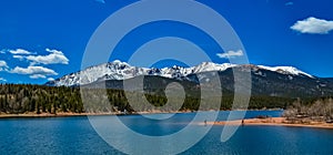 Panorama Snow-capped and forested mountains near a mountain lake, Pikes Peak Mountains in Colorado Spring, Colorado, US