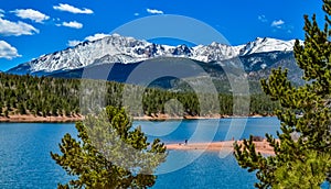 Panorama Snow-capped and forested mountains near a mountain lake, Pikes Peak Mountains in Colorado Spring, Colorado, US