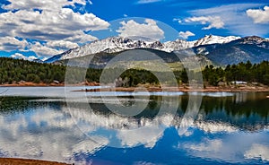 Panorama Snow-capped and forested mountains near a mountain lake, Pikes Peak Mountains in Colorado Spring, Colorado, US