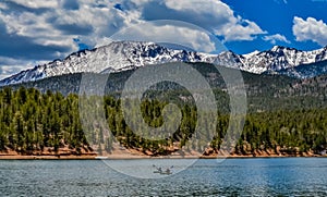 Panorama Snow-capped and forested mountains near a mountain lake, Pikes Peak Mountains in Colorado Spring, Colorado, US