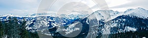 Panorama of snow-capped mountains, snow and clouds on the horizon