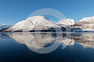 Panorama of snowy fjords and mountain range, Senja, Norway Amazing Norway nature seascape popular tourist attraction.