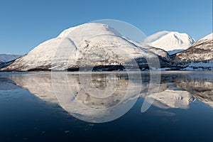 Panorama of snowy fjords and mountain range, Senja, Norway Amazing Norway nature seascape popular tourist attraction.