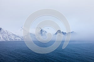 Panorama of snowy fjords and mountain range, Senja, Norway Amazing Norway nature seascape popular tourist attraction.