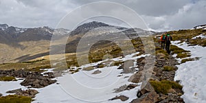panorama of a snowy landscape with hiker in Sierra Nevada photo