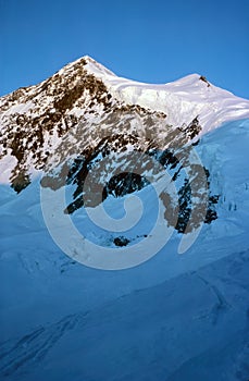 Panorama of snowy mountains and high alpine peaks in wintery Bernese Oberland in Switzerland