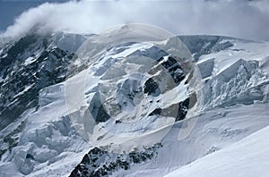 Panorama of snowy mountains and high alpine peaks in wintery Bernese Oberland in Switzerland