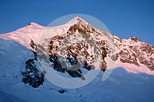 Panorama of snowy mountains and high alpine peaks in wintery Bernese Oberland in Switzerland